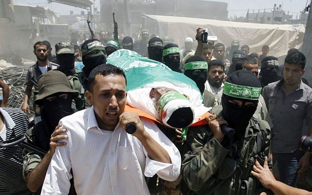 Palestinian militants of the Izz ad-Din al-Qassam Brigades, Hamas's armed wing, carry the body of militant Mohammed Obied during his funeral in the town of Deir al-Balah, in the central Gaza Strip on June 30, 2014 (photo credit: Abed Rahim Khatib/Flash90)