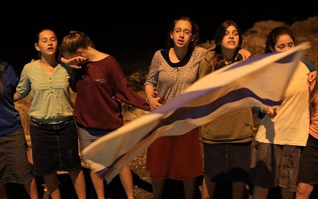 Young Israelis mourn near the Palestinian village of Halhul, on Monday night, after the bodies of three teenagers, Eyal Yifrach, Naftali Fraenkel and Gil-ad Shaar, were found in a field there. (Photo credit: Nati SHohat/FLASH90)