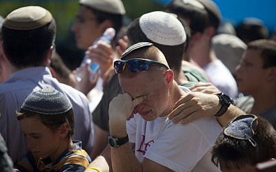 A mourner at the funeral for the three kidnapped teens in Modiin Tuesday. (photo credit: Flash90)