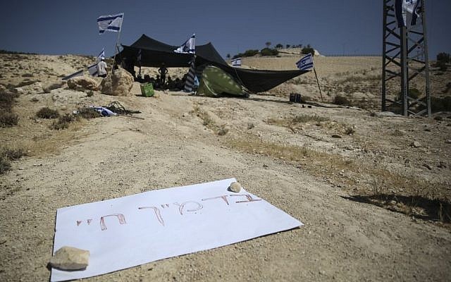 Jewish right-wing activists seen setting up tents and establishing an outpost on a hill in the controversial E1 area near Maale Adumim, in response to the murder of three young Jewish boys, Eyal Yifrach, Gilad Sha'ar and Naftali Fraenkel. (photo credit: Hadas Parush/Flash90)