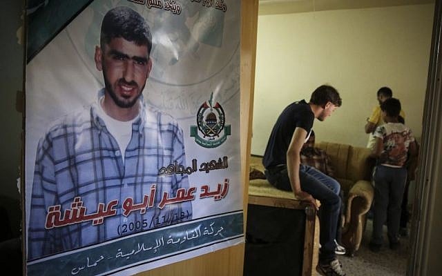 A poster of Amer Abu Aysha hangs on the door inside his family home in Hebron, in the West Bank, which was bombed by IDF overnight, July 1, 2014. (photo credit: Hadas Parush/Flash90)