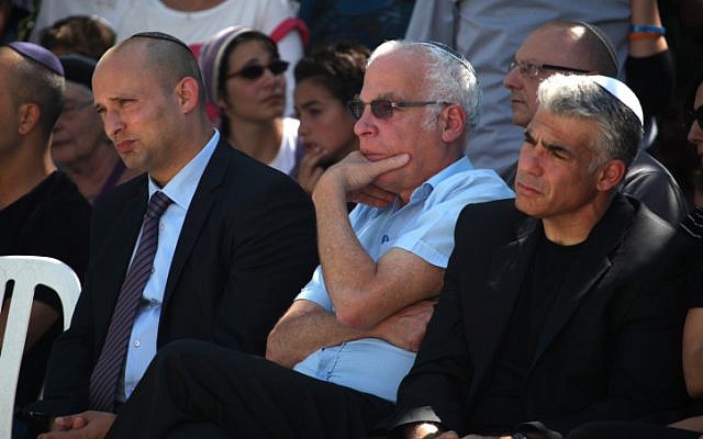 Economy Minister Naftali Bennett (L), Housing Minister Uri Ariel (C), and Finance Minister Yair Lapid (R) attend the funeral of Gil-ad Shaar, 16, in Talmon on July 1, 2014. (photo credit: Flash90)