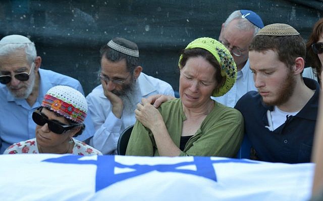 Rachelle Fraenkel crying over the body of her son Naftali at his funeral, July 2014 (photo credit: Flash90)