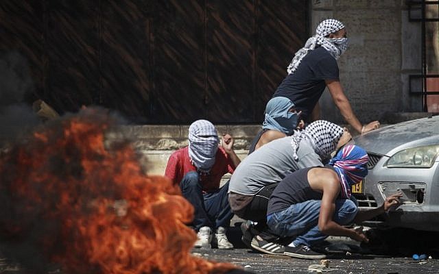 Palestinians clash with Israeli border police in the East Jerusalem neighborhood of Shuafat following the discovery of the body of a Palestinian teen from East Jerusalem who was found in the Jerusalem forest, in a suspected revenge attack for the killing of three Jewish teens. July 02, 2014. (Photo credit: Hadas Parush/FLASH90) Palestinians clash with Israeli border police in the East Jerusalem neighborhood of Shuafat following the discovery of the body of a Palestinian teen from East Jerusalem who was found in the Jerusalem forest, in a suspected revenge attack for the killing of three Jewish teens. July 02, 2014. (Photo credit: Hadas Parush/FLASH90)