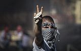 A Palestinian holds up a rock during clashes with police in Jerusalem after the body of Muhammed Abu Khdeir was found early Wednesday morning (photo credit: Hadas Parush/FLASH90)