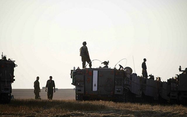 IDF soldiers seen with M113 armored personnel carriers deployed in a field near the Gaza border in southern Israel, on July 6, 2014. (photo credit: Hadas Parush/Flash90) IDF soldiers seen with M113 armored personnel carriers deployed in a field near the Gaza border in southern Israel, on July 6, 2014. (photo credit: Hadas Parush/Flash90)