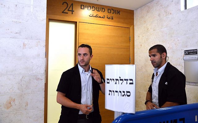Israeli security guards stand outside the courtroom where the indictment for the murder of Muhammed Abu Khdeir, 16, is handed down. (photo credit: Flash90) Israeli security guards stand outside the courtroom where the indictment for the murder of Muhammed Abu Khdeir, 16, is handed down. (photo credit: Flash90)