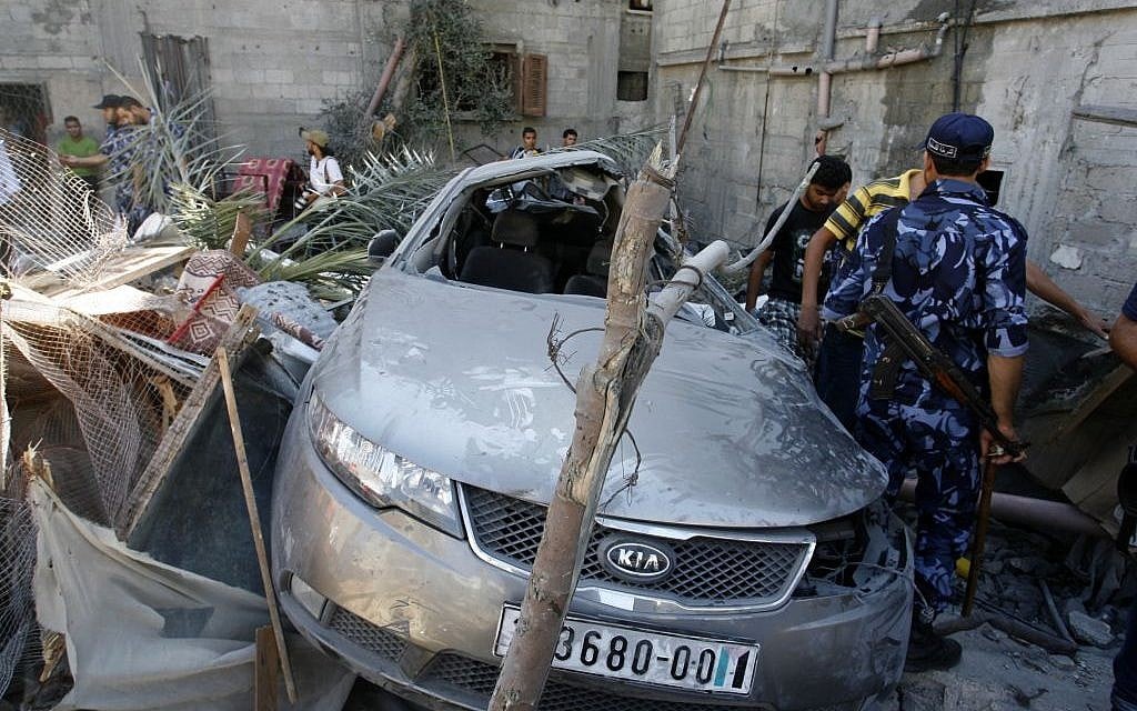 Palestinians inspect a house which police said was destroyed in an Israeli air strike in Khan Younis in the southern Gaza Strip on July 8, 2014. (Photo credit: Abed Rahim Khatib/Flash90)