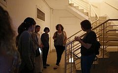 Israelis take cover in the hallway of an apartment building as a Code Red alert sounds in Jerusalem, Tuesday, July 8, 2014. (Miriam Alster/ Flash90)