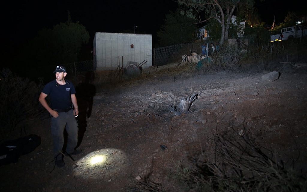 Israeli police inspect the site where a rocket fired by Palestinian militants from Gaza, hit in the area of Ramat Raziel, near Jerusalem. July 8, 2014. (photo credit: Nati Shohat/Flash90)
