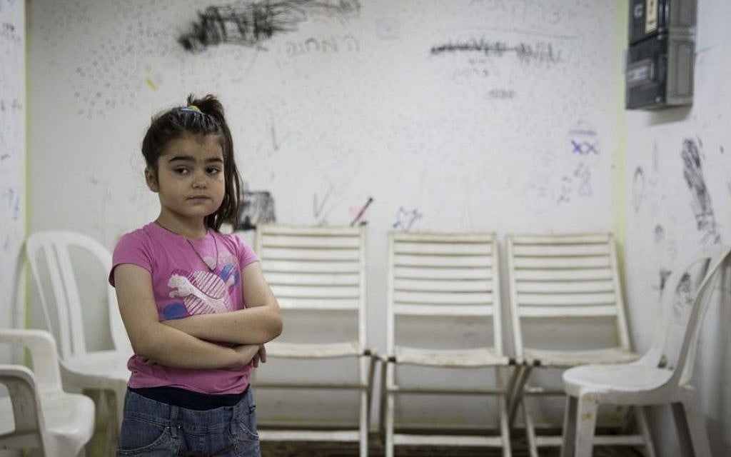 A young Israeli girl is seen in a bomb shelter of an apartment building in Ashkelon, southern Israel, on the third day of Operation Protective Edge, Thursday, July 10, 2014. Over 360 rockets were fired from Gaza into Israel over the past three days. (photo credit: Hadas Parush/Flash90)