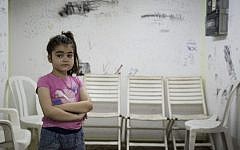 A young Israeli girl is seen in a bomb shelter of an apartment building in Ashkelon, southern Israel, on the third day of Operation Protective Edge, Thursday, July 10, 2014. Over 360 rockets were fired from Gaza into Israel over the past three days. (photo credit: Hadas Parush/Flash90)