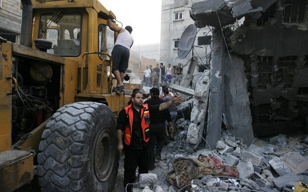 Palestinians remove the rubble of the Ghanam family home after it was targeted in an Israeli air raid on Rafah, in the southern of Gaza strip, on July 11, 2014. Five Palestinians, including a woman and seven-year-old child, died when the home of a Hamas operative was hit, Gaza emergency services said. (Photo credit: Abed Rahim Khatib/Flash90)