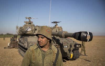 Israeli Artillery Corps soldiers seen in a field near the border with Gaza in South Israel, on the fourth day of Operation Protective Edge, July 11, 2014. (photo credit: Hadas Parush/Flash90)