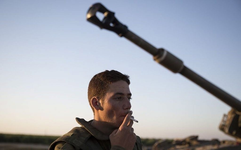 An Artillery Corps soldier is seen in a field near the border with Gaza in southern Israel, on the fourth day of Operation Protective Edge, July 11, 2014. (photo credit: Hadas Parush/Flash90)