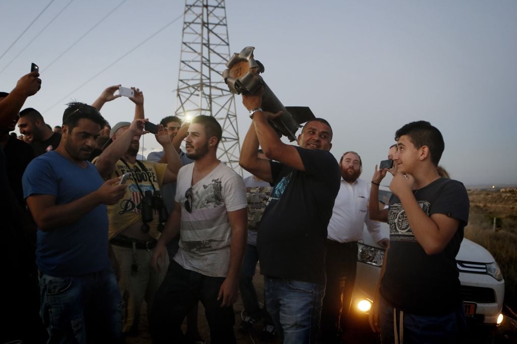 Residents of Sderot looking at a piece of a rocket that fell in an open field (photo credit: Miriam Alster/Flash 90) Residents of Sderot looking at a piece of a rocket that fell in an open field (photo credit: Miriam Alster/Flash 90)