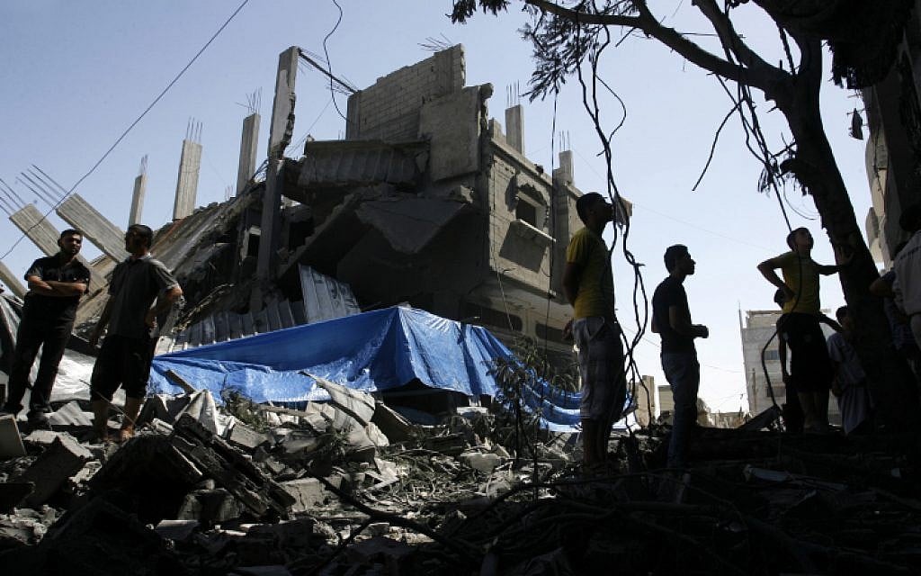 Palestinians seen walking among the rubble of a destroyed house following an Israeli missile strike, in Rafah on July 14, 2014. (photo credit: Abed Rahim Khatib/Flash90) Palestinians seen walking among the rubble of a destroyed house following an Israeli missile strike, in Rafah on July 14, 2014. (photo credit: Abed Rahim Khatib/Flash90)