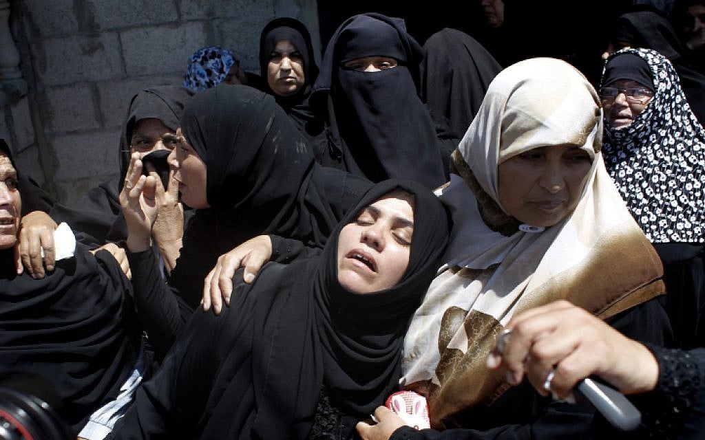 Palestinian relatives mourn during the funeral of four members of the Moamer family, including a 26-year-old militant of the Hamas movement, during their funeral in southern Gaza Strip city of Rafah on July 14, 2014 (photo credit: Abed Rahim Khatib/Flash90)