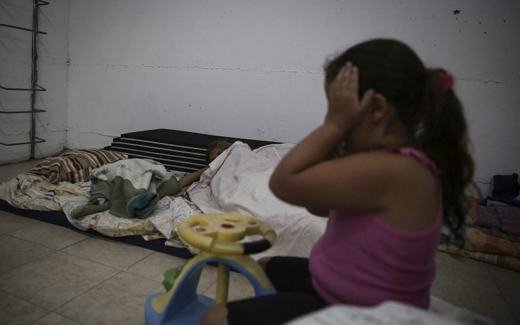 A girl sits in her building bomb shelter in the southern city of Ashkelon, July 14, 2014. (photo credit: Hadas Parush/Flash90)
