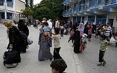 Palestinians at an UNRWA school after fleeing their homes following an Israeli ground offensive in Rafah in the southern Gaza Strip, on July 18, 2014. (photo credit: Abed Rahim Khatib/Flash90)