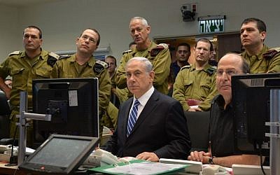 Illustrative: Prime Minister Benjamin Netanyahu with IDF chief Lt. Gen. Benny Gantz (standing directly behind him) and then-defense minister Moshe Ya'alon (seated right), monitoring IDF ground operations in Gaza during a meeting at the Kirya military headquarters in Tel Aviv on July 18, 2014. (Haim Zach/GPO/Flash90)