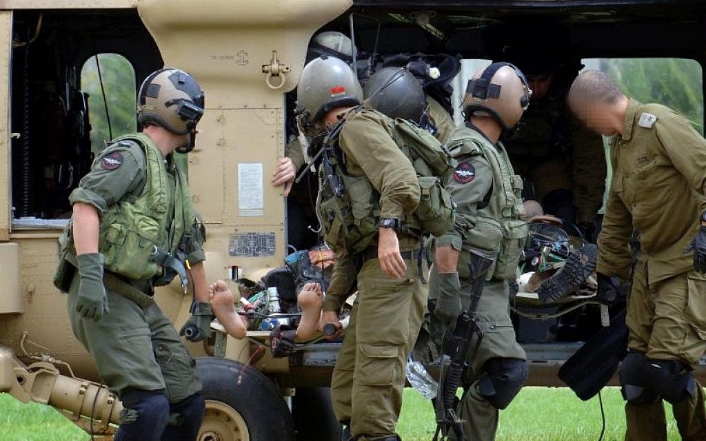 An Israeli soldier injured on the Israel-Gaza border is carried into Soroka hospital in Beersheba on July 19, 2014 (Photo credit: Flash90)
