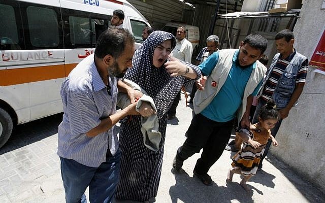 A Palestinian woman is helped out of an ambulance as she arrives at al-Najar hospital following an Israeli air raid on Rafah in the southern of Gaza strip, on July 20, 2014 (photo credit: Abed Rahim Khatib/Flash90) A Palestinian woman is helped out of an ambulance as she arrives at al-Najar hospital following an Israeli air raid on Rafah in the southern of Gaza strip, on July 20, 2014 (photo credit: Abed Rahim Khatib/Flash90)