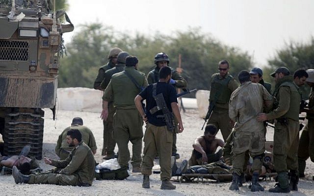 An Israeli soldier, wounded in Gaza, is evacuated near the border on July 20, 2014. (Photo credit: Flash90)