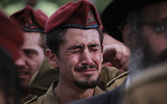 IDF soldiers mourning at the funeral of Sergeant Benaya Rubel, at the Holon Military Cemetery on July 20, 2014. The 20 year old paratrooper was killed by Hamas gunmen in Gaza on the second day of Operation Protective Edge. (Photo credit: Hadas Parush/Flash90)