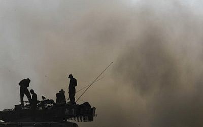 Israeli soldiers seen on top of Merkava tanks near the Israeli border with Gaza on July 24, 2014, as Operation Protective Edge entered it's 17th day. (Photo credit: Miriam Alster/FLASH90)