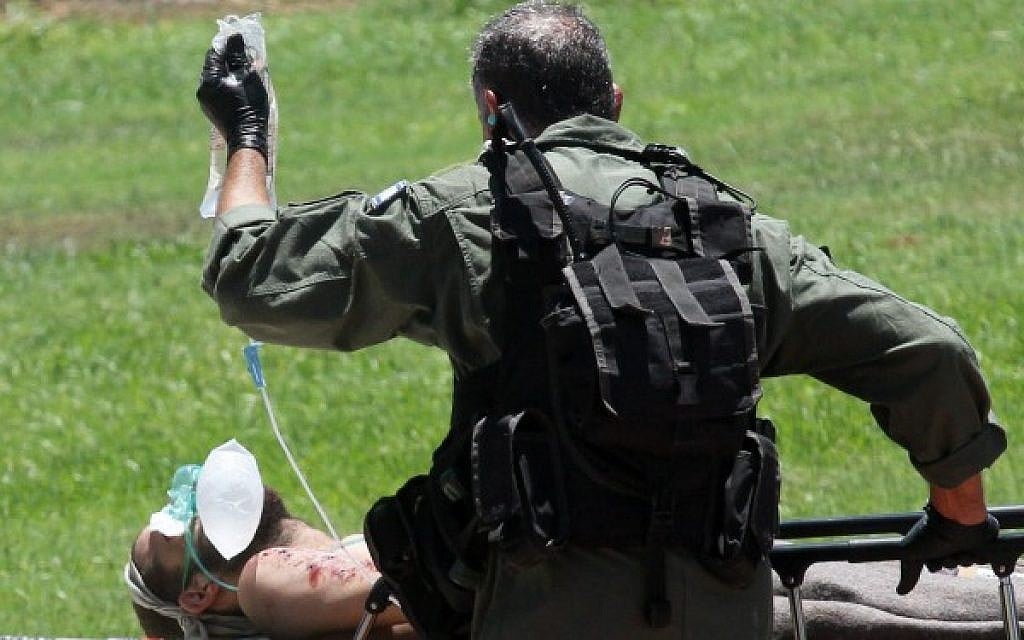 Soldiers wounded in combat in Gaza, are led to the emergency room at Tel Hashomer hospital in Tel Aviv, after being evacuated from the field by helicopter, on July 25, 2014. (Photo credit: Flash90)