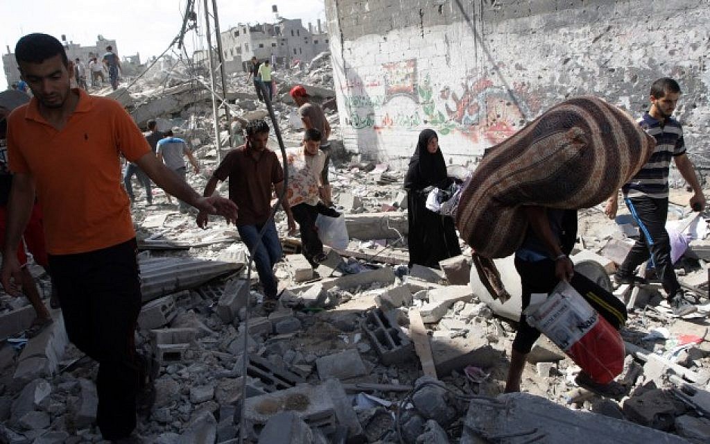 Palestinians inspect the rubble of destroyed houses in the Shejayia neighborhood, which witnesses said was heavily hit by Israeli shelling and air strikes during an Israeli offensive, on Gaza City July 26, 2014. (Photo credit: Abed Rahim Khatib/Flash90)