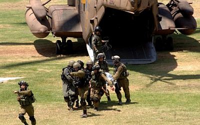 Soldiers wounded in combat in Gaza are led to the emergency room at Soroka Hospital in Beersheba, after being evacuated from the field by helicopter, on July 25, 2014. (Dudu Greenspan/Flash90)