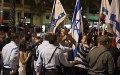 Right-wing Israelis wave the Israeli flag during a demonstration in Rabin square in Tel Aviv, as they rally in support of Israel's offensive in the Gaza Strip ,July 26, 2014. (photo credit: Danielle Shitrit/FLASH90)