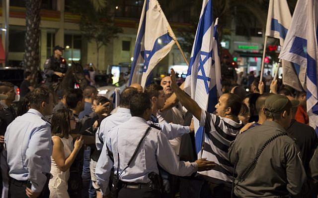 Right-wing Israelis wave the Israeli flag during a demonstration in Rabin square in Tel Aviv, as they rally in support of Israel's offensive in the Gaza Strip ,July 26, 2014. (photo credit: Danielle Shitrit/FLASH90) Right-wing Israelis wave the Israeli flag during a demonstration in Rabin square in Tel Aviv, as they rally in support of Israel's offensive in the Gaza Strip ,July 26, 2014. (photo credit: Danielle Shitrit/FLASH90)