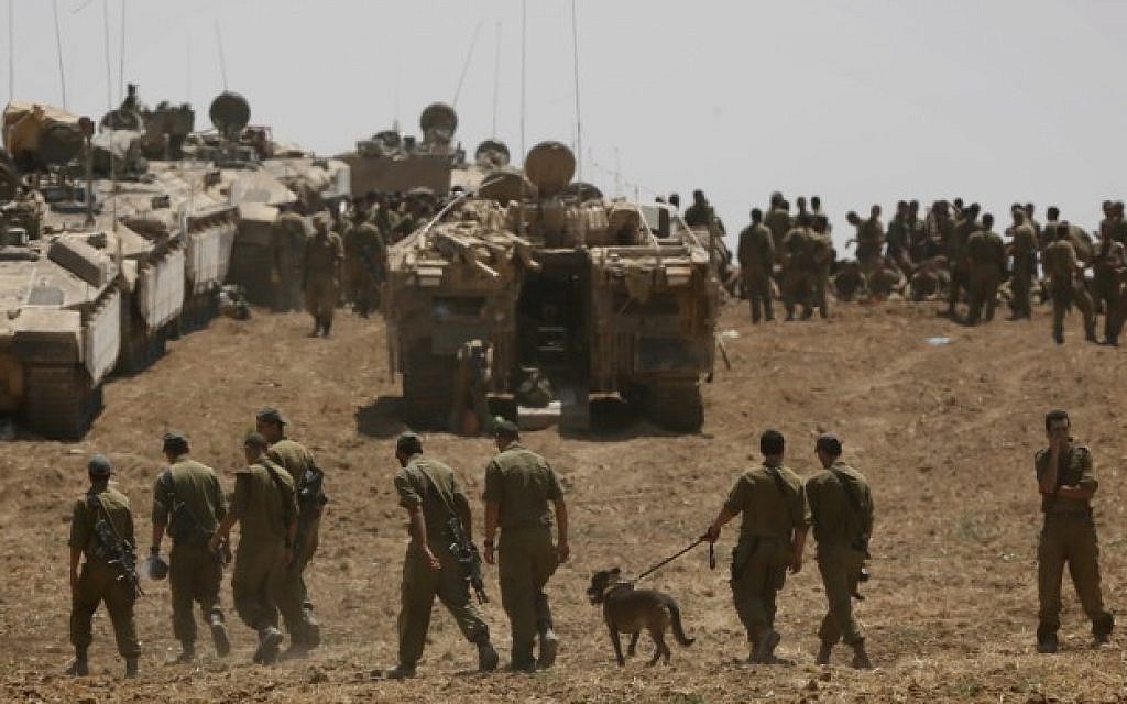 Israeli soldiers seen at an IDF gathering point in a field near the Israeli border with Gaza, July 27, 2014. (photo credit: Miriam Alster/Flash90)