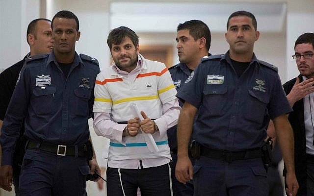 Police escort Yosef Haim Ben-David, one of the Jewish suspects of the murder of Muhammed Abu Khdeir, in the Disctrict Court in Jerusalem, July 27, 2014. (photo credit: Yonatan Sindel/Flash90)