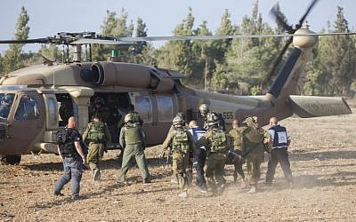 An injured Israeli soldier is evacuated by helicopter from near the Israeli border with Gaza Strip on July 28, 2014, (photo credit: Yonatan Sindel/Flash90) 