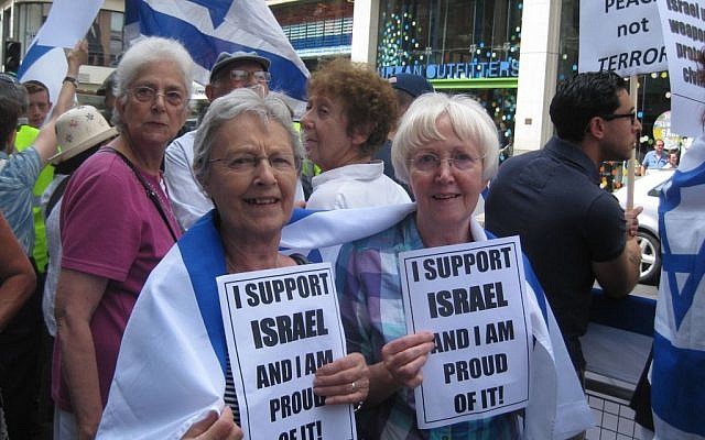 Women hold signs stating 'I support Israel and I am proud of it' at a London rally on Sunday, July 20, 2014 (Jennifer Lipman/The Times of Israel)