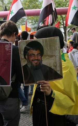 Protesters hold photos of Hezbollah chief Hassan Nasrallah at Al Quds day demonstration in Berlin, July 25, 2014. (Photo credit: Micki Weinberg)