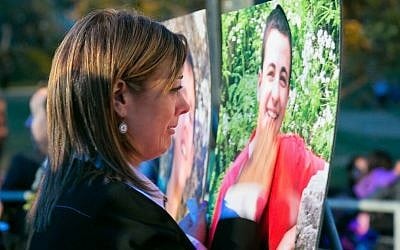 Leehy Shaar in front of a photo of Gil-ad at a June 19, 2014 vigil at Pan Pacific Park in Los Angeles. (Photo credit: Marvin Steindler)