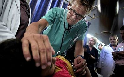 Mads Gilbert, Norwegian doctor who has volunteered at Shifa on and off for 17 years, treats a Palestinian girl in the emergency room of the Shifa Hospital in Gaza City. (photo credit: AP/Khalil Hamra) Mads Gilbert, Norwegian doctor who has volunteered at Shifa on and off for 17 years, treats a Palestinian girl in the emergency room of the Shifa Hospital in Gaza City. (photo credit: AP/Khalil Hamra)