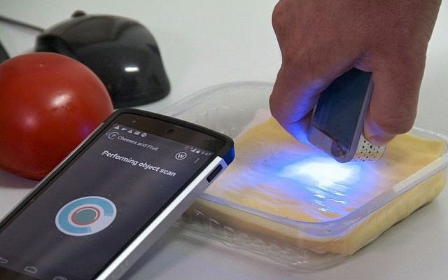 A man works with a pocket-sized scanner called SCiO at the Consumer Physics laboratory near Tel Aviv, Israel. (AP Photo/Jon Gerberg)
