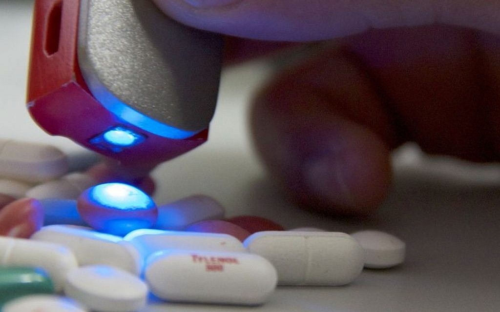 In this Wednesday, May 28, 2014 photo, a man works with a pocket-sized scanner called SCiO at the Consumer Physics laboratory near Tel Aviv, Israel. The scanner can identify the molecular structure of a substance by shining an infrared light on an object and reading its chemical makeup. It can then send additional information to a smartphone. (AP Photo/Jon Gerberg)
