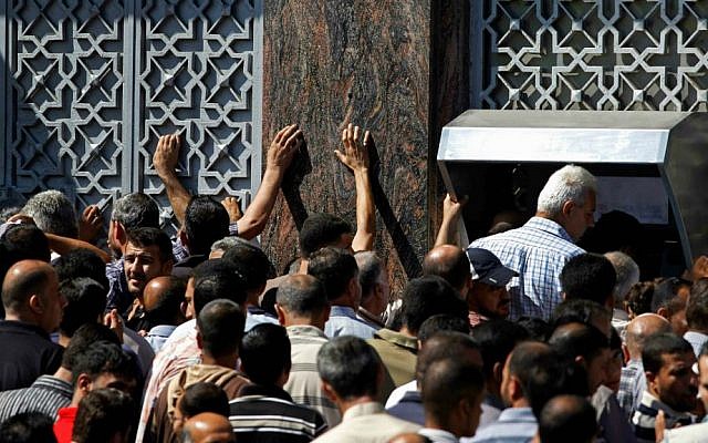Palestinians gather to withdraw money from ATM machines in Gaza City, Thursday, July 17, 2014. (AP Photo/Lefteris Pitarakis)