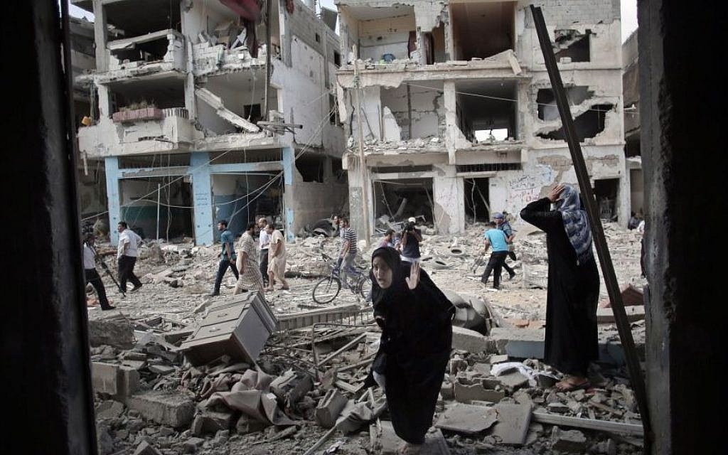 A Palestinian woman reacts after seeing her destroyed house during a 12-hour cease-fire in Gaza City's Shejaiya neighborhood, Saturday, July 26, 2014. (Photo credit: AP/Khalil Hamra)