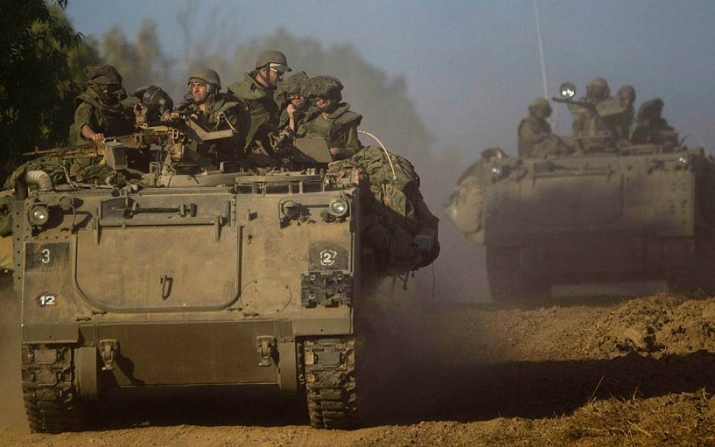 Israeli soldiers drive an armored personnel carrier to a position near the Israel Gaza border, Thursday, July 10, 2014. (AP Photo/Ariel Schalit)