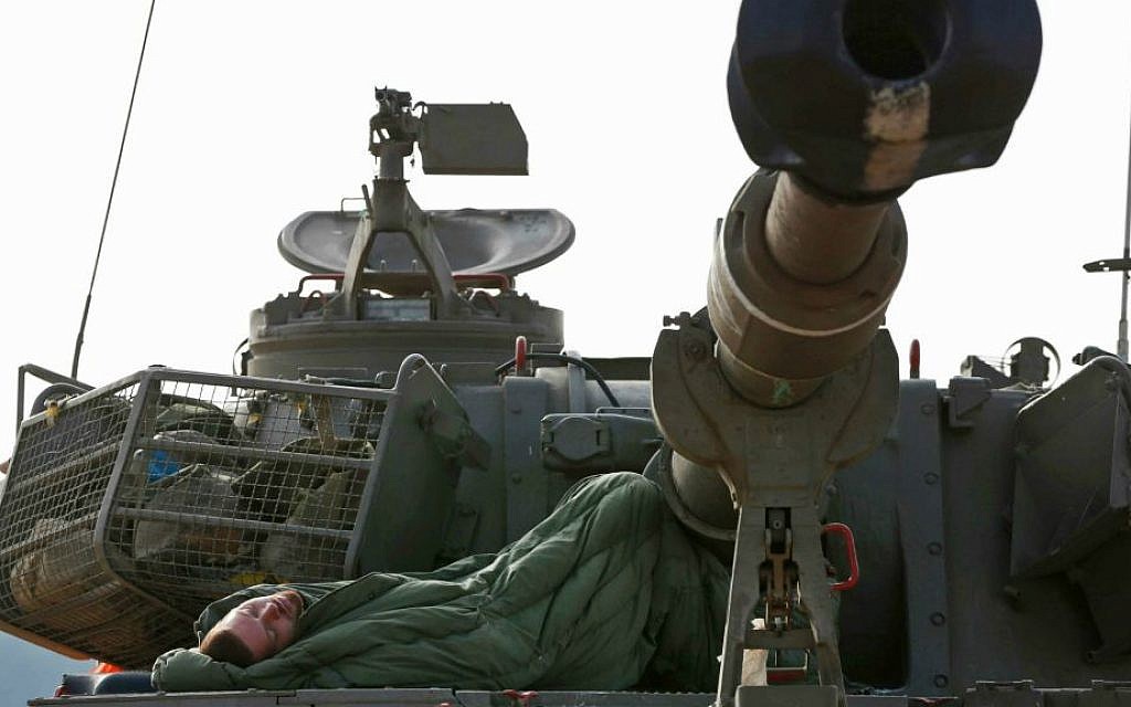 An Israeli soldier sleeps on a mobile artillery unit at a position on the Israel-Gaza border, Friday, July 11, 2014. (AP Photo/Lefteris Pitarakis)