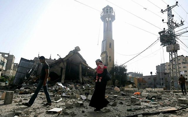 Illustrative photo of Palestinians walking past the ruins of a mosque after that was hit by an Israeli missile strike, in the central Gaza Strip (AP Photo/Hatem Moussa) Illustrative photo of Palestinians walking past the ruins of a mosque after that was hit by an Israeli missile strike, in the central Gaza Strip (AP Photo/Hatem Moussa)