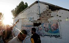 Palestinians gather outside a classroom at the Abu Hussein UN school in Jabaliya refugee camp, northern Gaza Strip, allegedly hit by an Israeli strike earlier, on Wednesday, July 30, 2014. (photo credit: AP Photo/Lefteris Pitarakis)